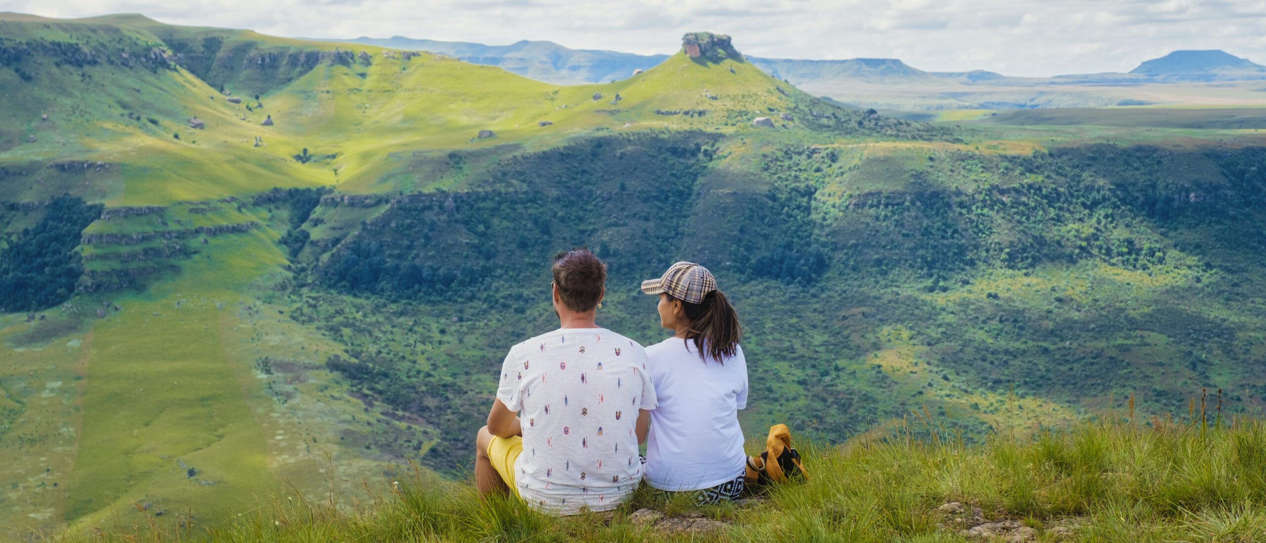 Young couple men andwoman hiking in the mountains of Drakensberg South Africa