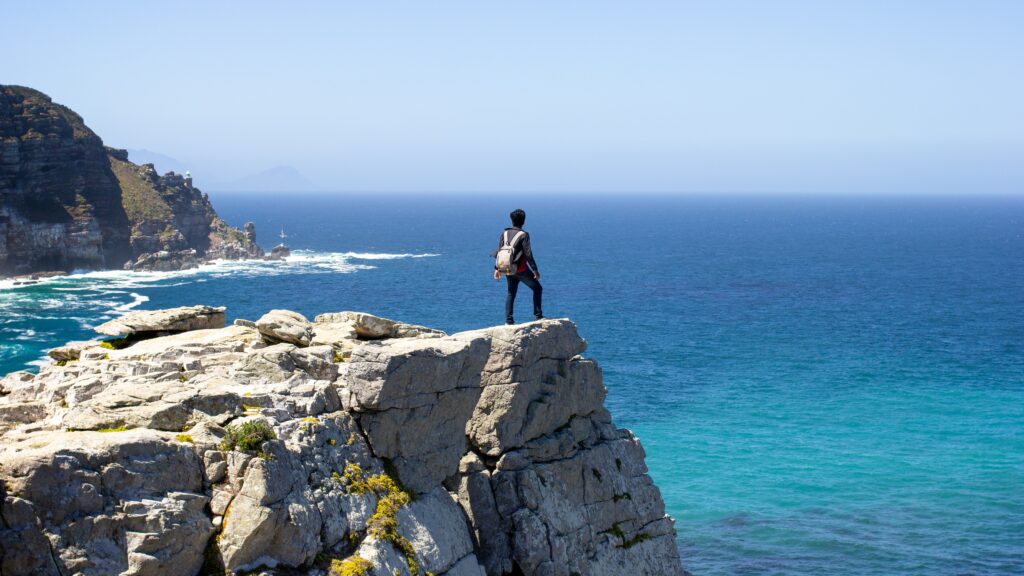 Traveler standing on a cliff at Cape Point