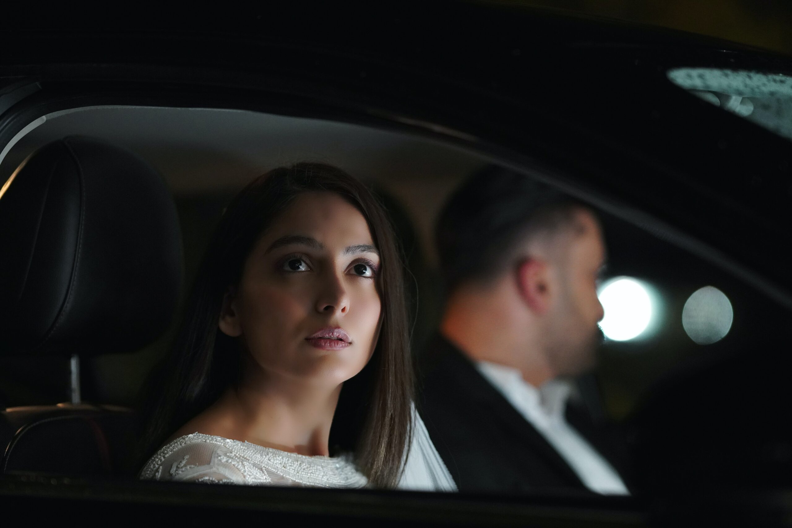 Man and woman driving at night