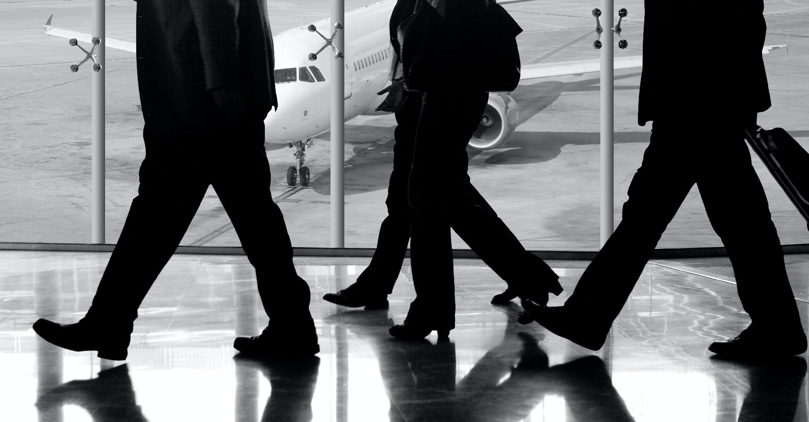 Businessmen and women arriving at the airport, ready to rent a SANI Car Rental and get to their meeting