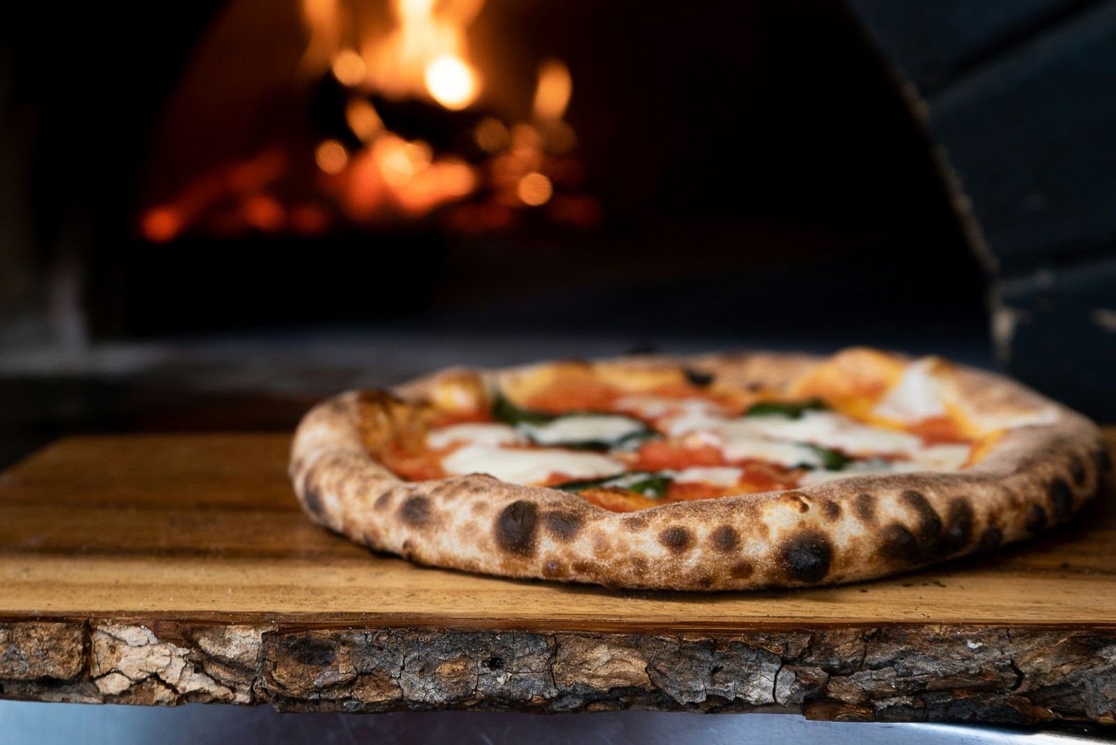 A photo of a delicious pizza fresh out of the wood fired oven