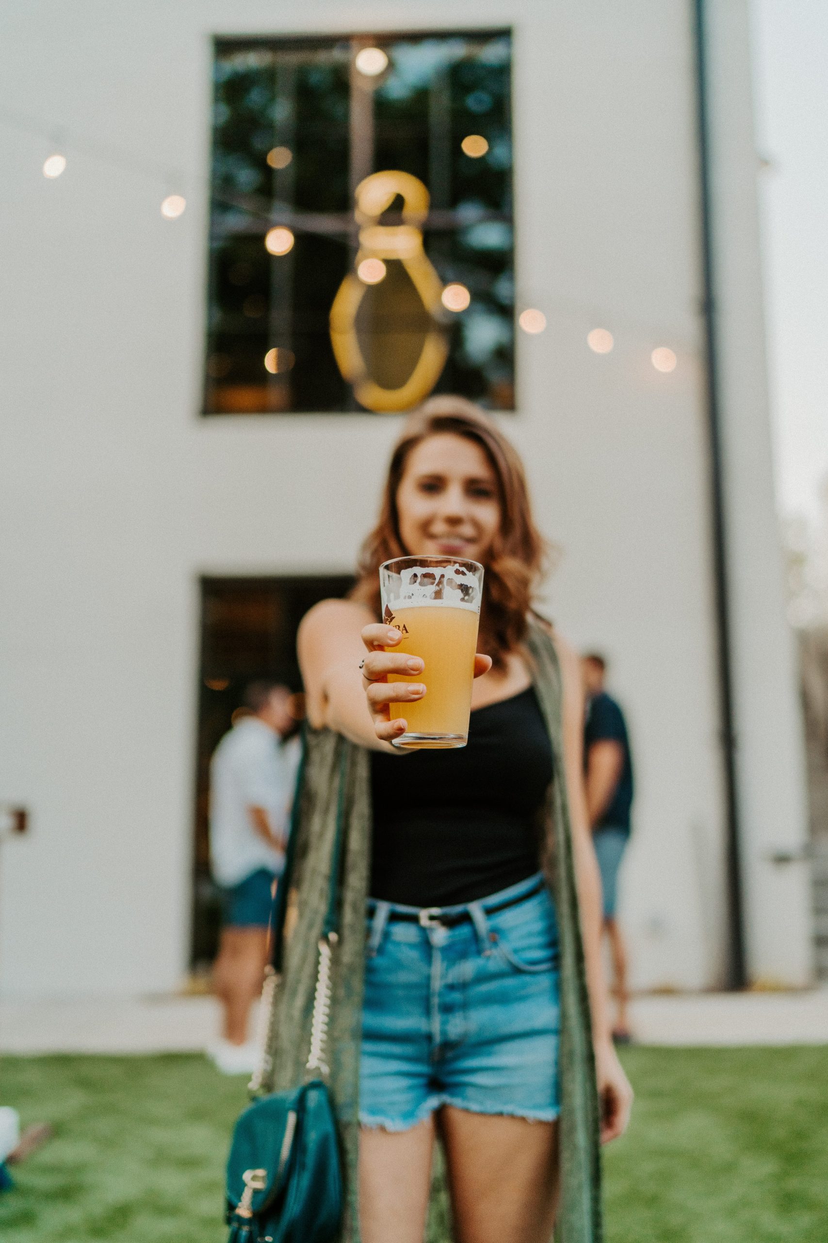 woman holding a craft beer