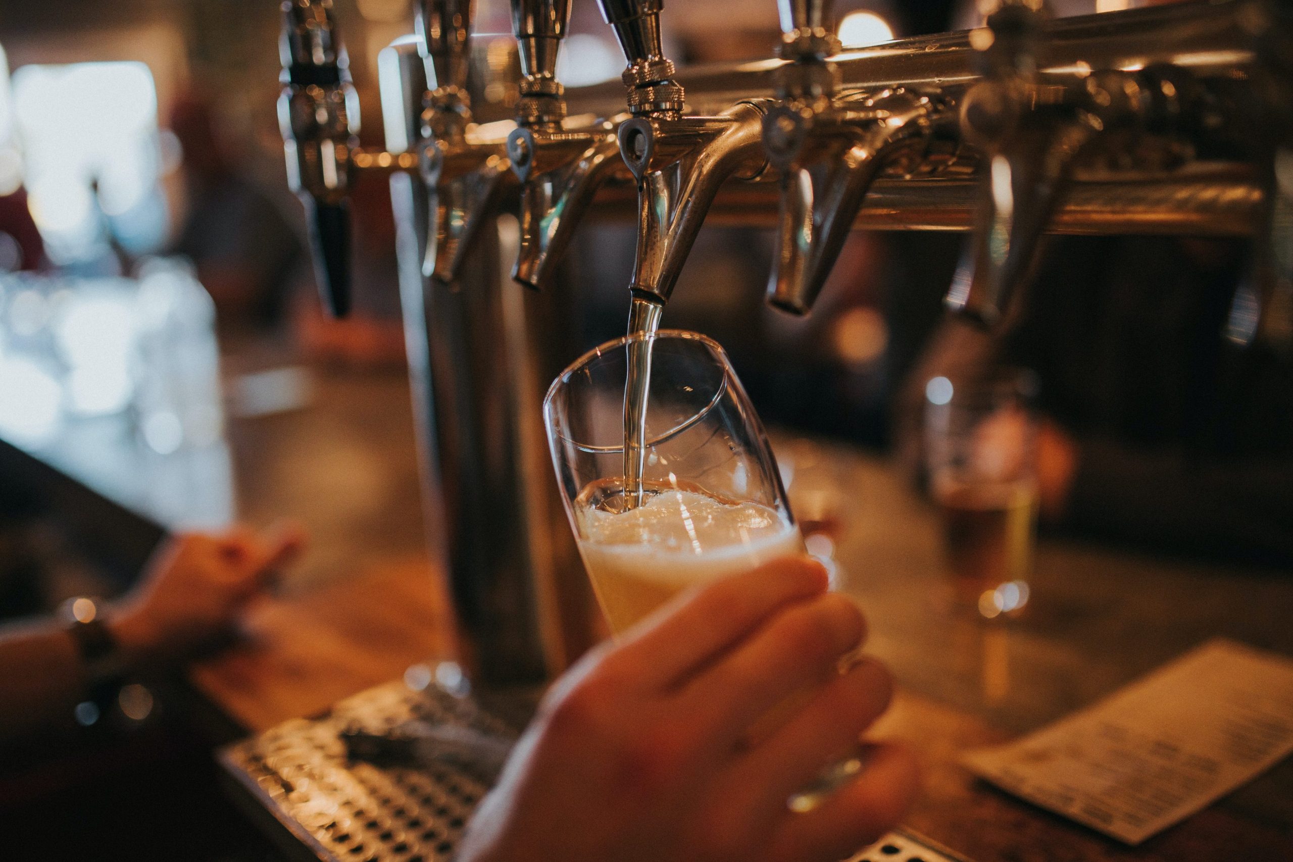 a craft beer being poured at toti brewing company