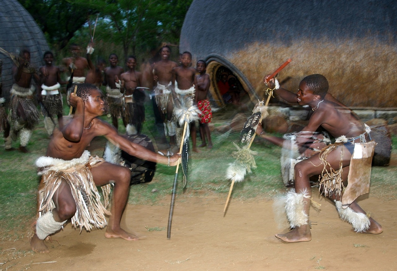 An image of taditionals zulu dancers acting out a knife fight