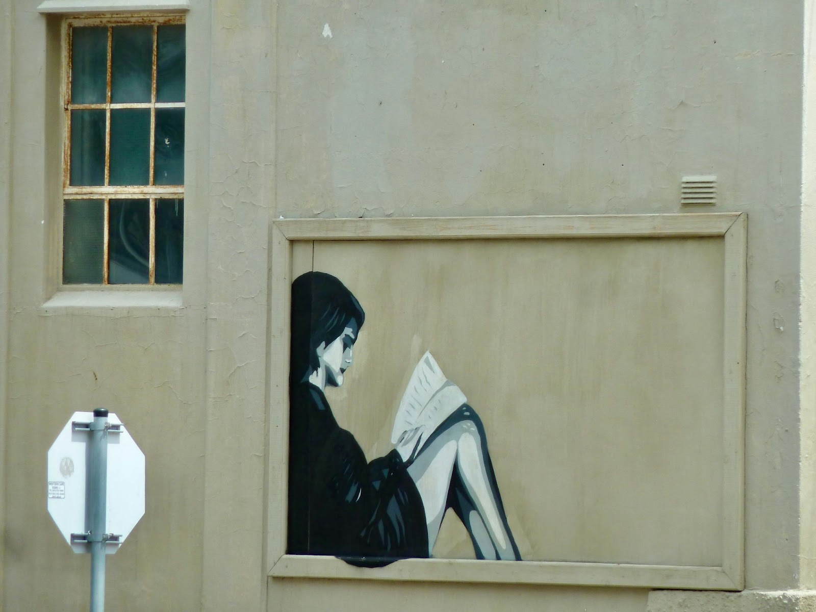 Cape Town street art of a lady reading a book