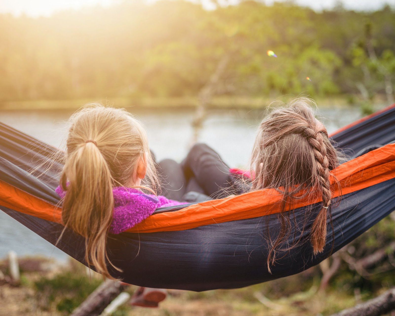 Two girls relaxing in a hammock while enjoying a weekend away