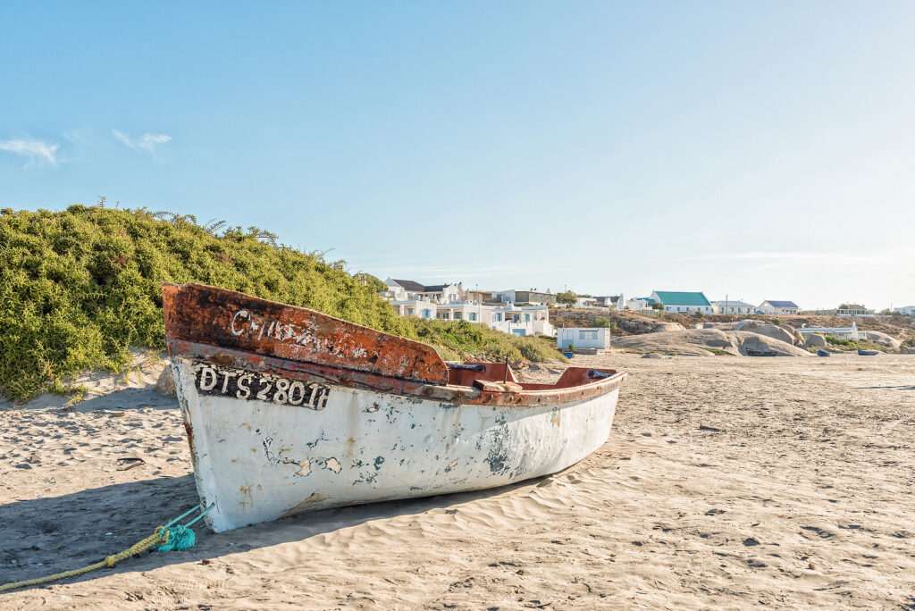 View of a fishing boat and houses at a beach in Paternoster a small town in the Western Cape Province